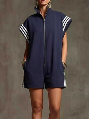 Navy blue zip-up romper with white stripes on sleeves and sides, pockets.