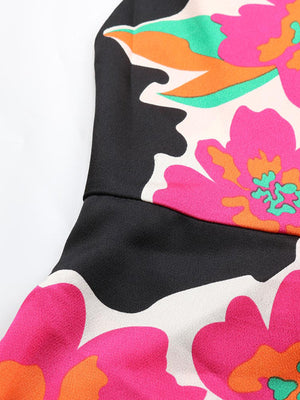 Vibrant floral midi dress with spaghetti straps in black with pink, orange, and green flowers.
