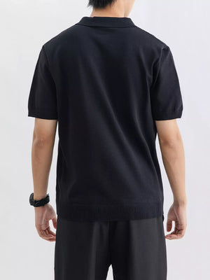 Black ribbed knit short sleeve polo shirt with a classic collar.