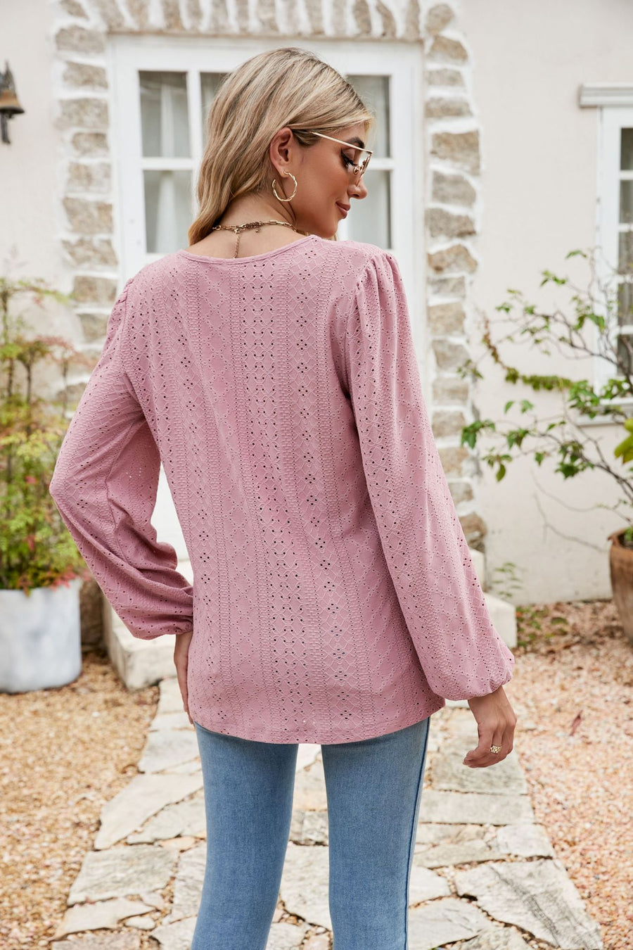 Dusty pink eyelet yoke blouse with blouson sleeves and textured fabric.