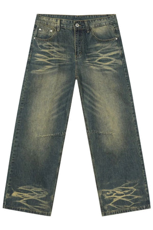 Distressed denim wide-leg trousers in medium wash with artisanal fading and whiskering details.