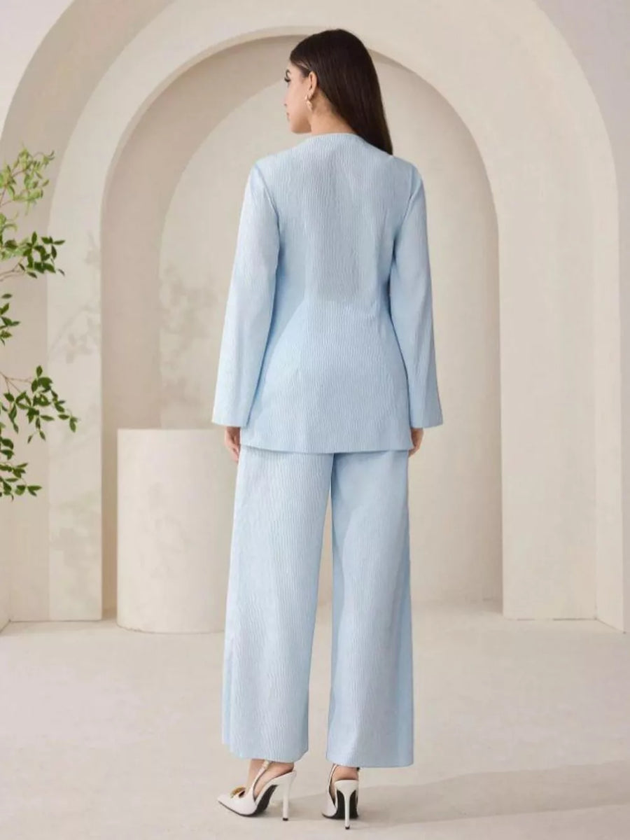Light blue crinkled texture two-piece set with wide-leg pants and long-sleeve top.
