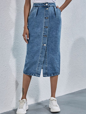Button-front denim midi skirt in light wash with pleats and a raw hem.