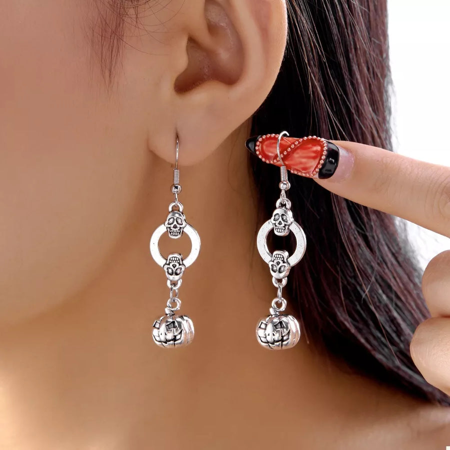 Silver earrings featuring dangle and novelty