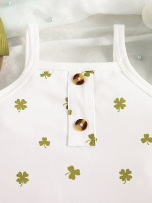 Baby bodysuit with clover print, button detail, and spaghetti straps.