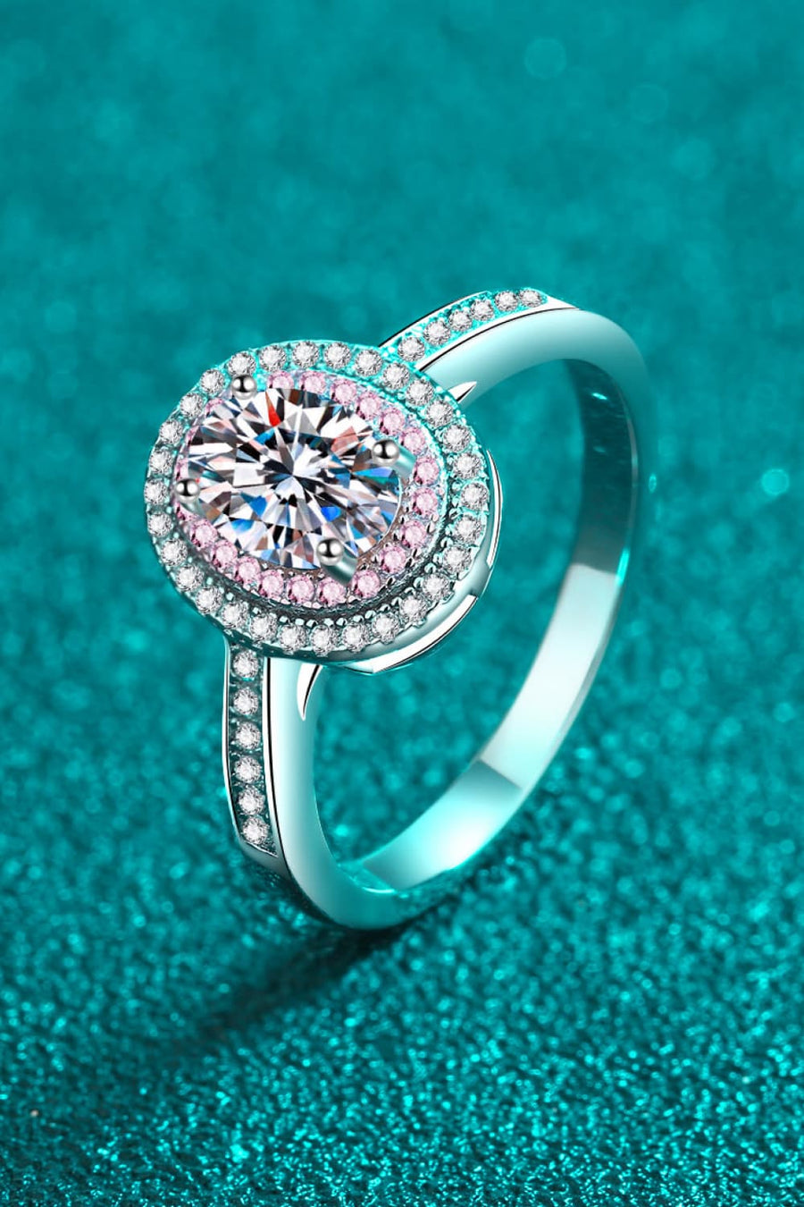 Silver ring with oval halo and pink stone accents