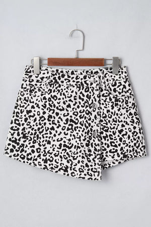 black denim shorts featuring decorative button and leopard-print
