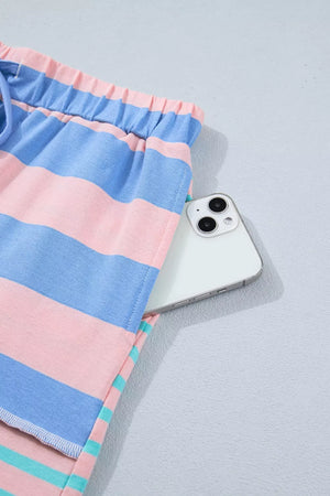 Striped shorts in pink, blue, and teal with a drawstring waist and a hidden pocket holding a smartphone.