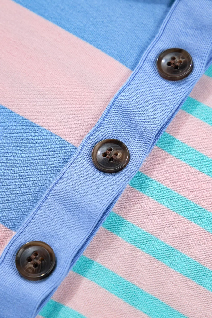 Striped knit cardigan with button front in pink, blue, and teal.