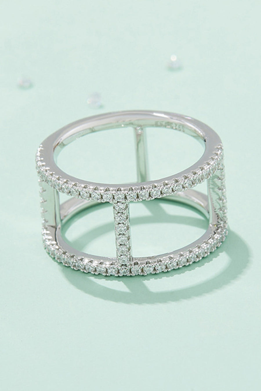 Silver geometric pave moissanite statement ring with open cage design.