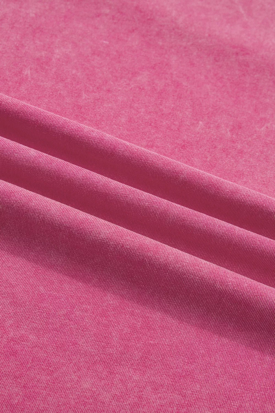 Pink mineral wash t-shirt with subtle texture and soft cotton fabric.