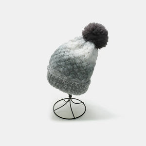 Gray ombre knit beanie with textured pattern and dark gray pom.