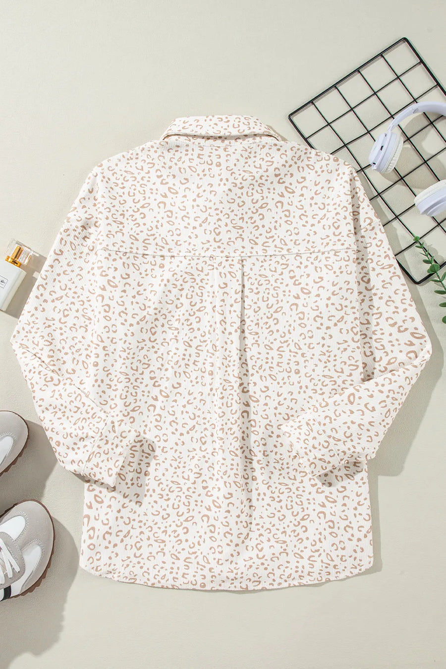 Leopard print overshirt with collared neckline and button-down front.