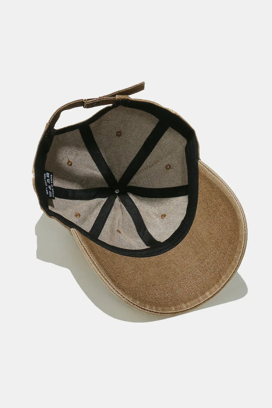 Caramel bleached heart baseball cap with adjustable strap and black interior lining.