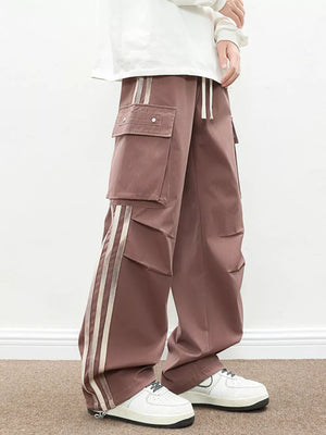 Oversized cargo pants in dusty pink with flap pockets and side stripe detail.