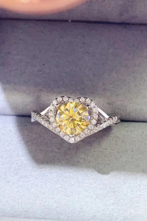 Yellow heart halo moissanite engagement ring in silver with diamond accents.