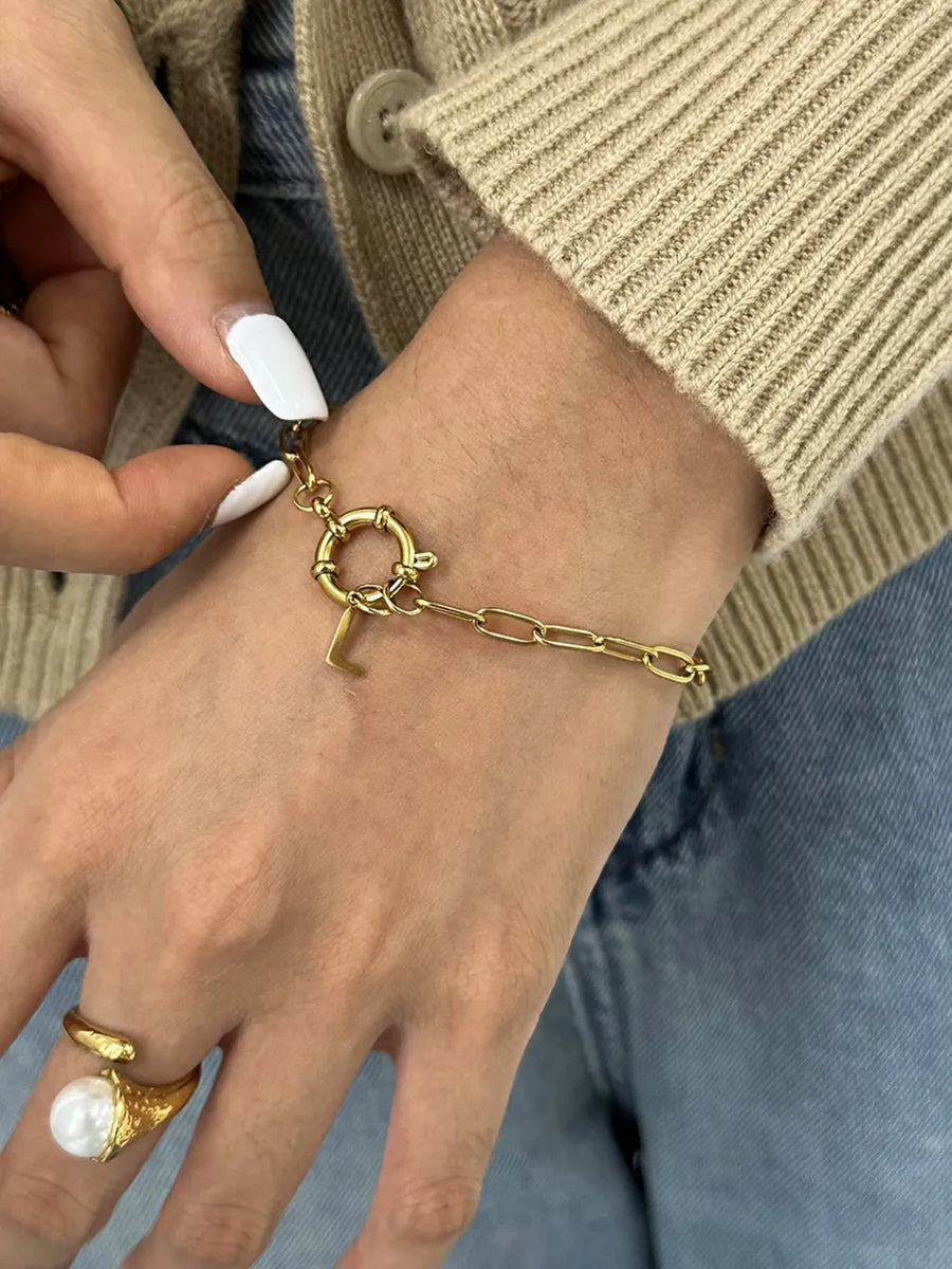 Gold chunky chain bracelet with an L initial charm and toggle clasp