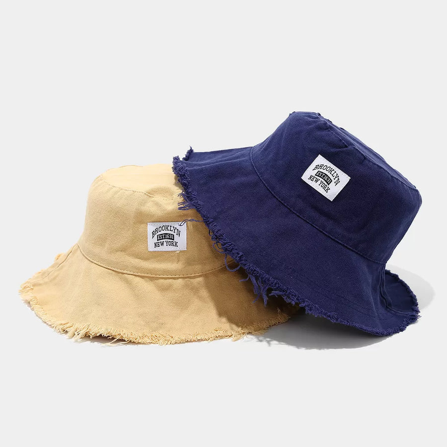 hat in mustard yellow featuring frayed hem and bucket fit