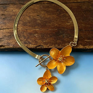 Gold anklet featuring flower charms and floral