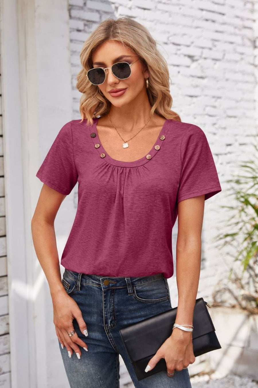 Button-trimmed gathered yoke top in watermelon pink with short sleeves and a scoop neckline.