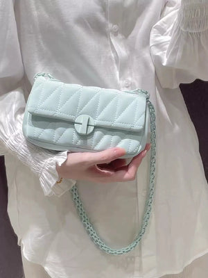 Mini quilted flap chain bag in light green with a turn-lock closure and matching chain strap.