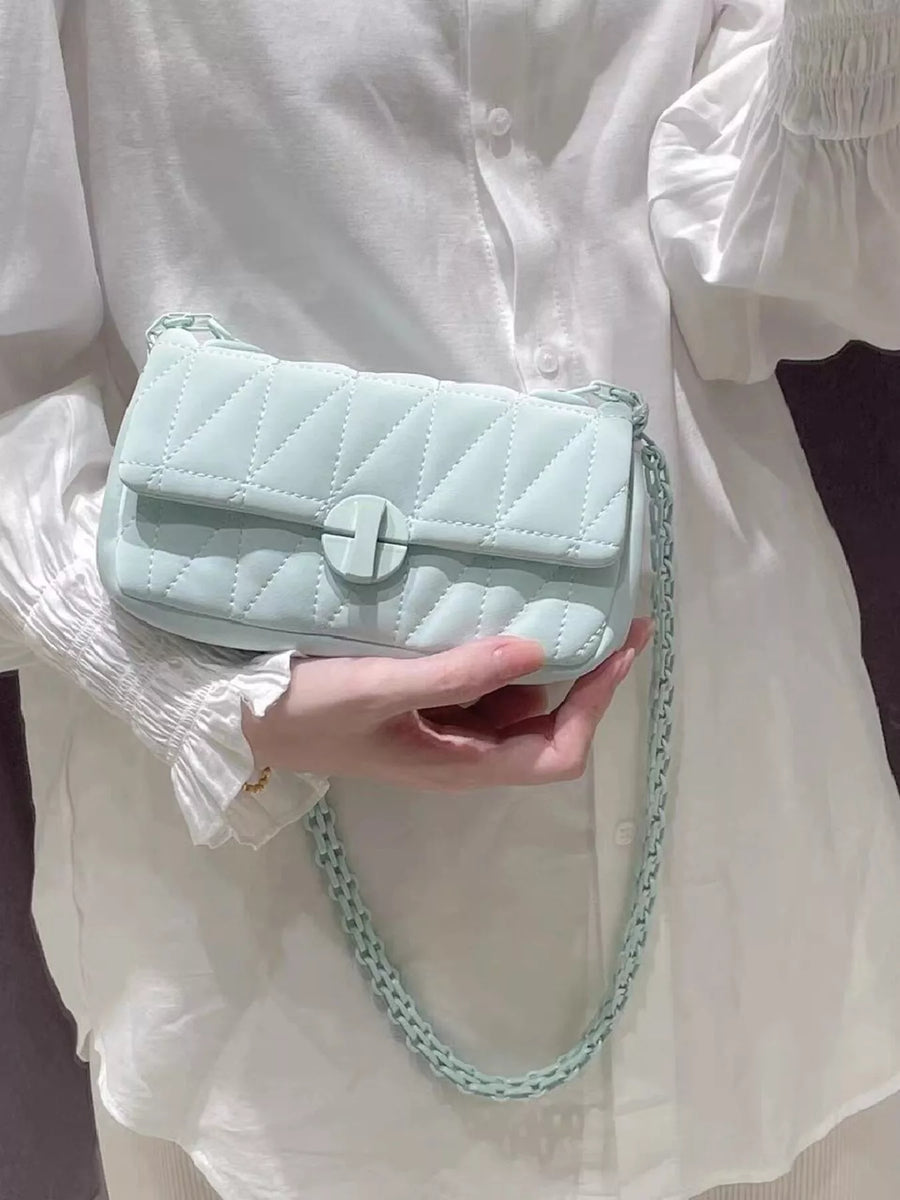 Mini quilted flap chain bag in light green with a turn-lock closure and matching chain strap.