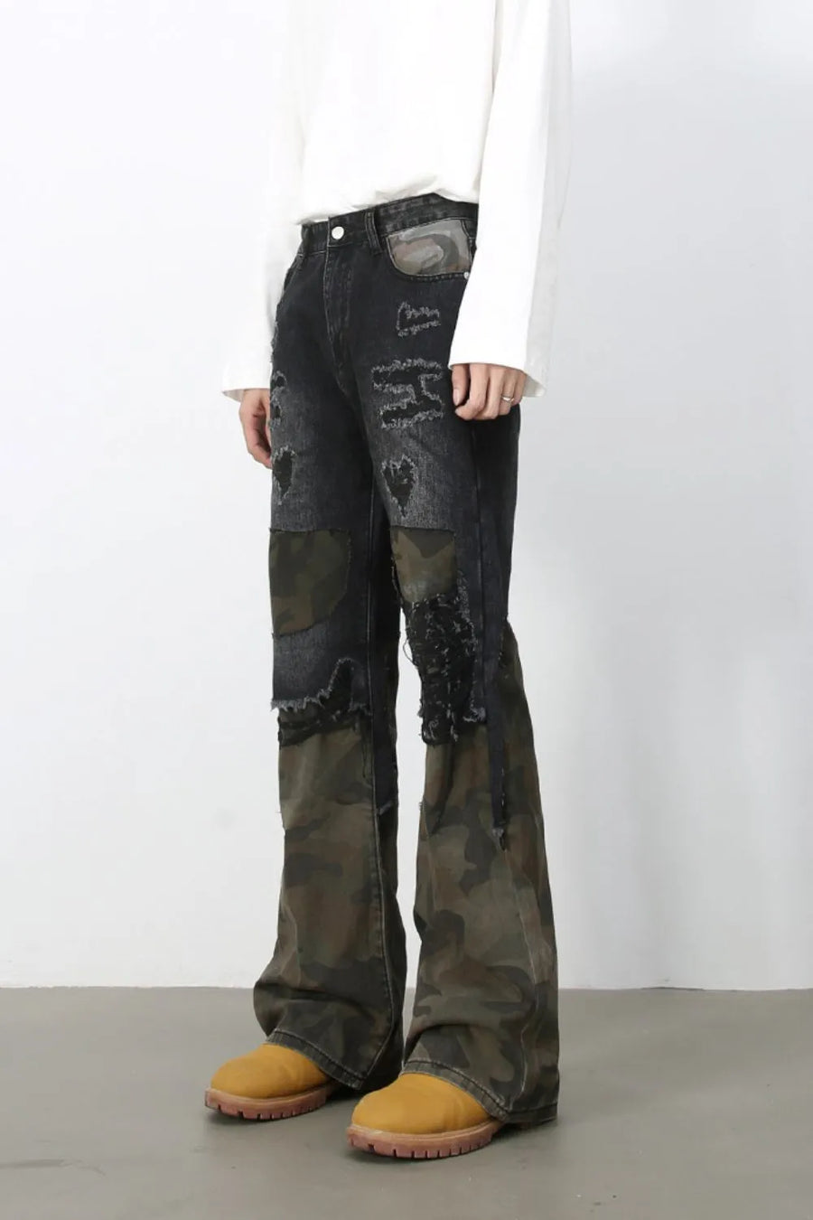 Distressed dark camo panel flare jeans with ripped details
