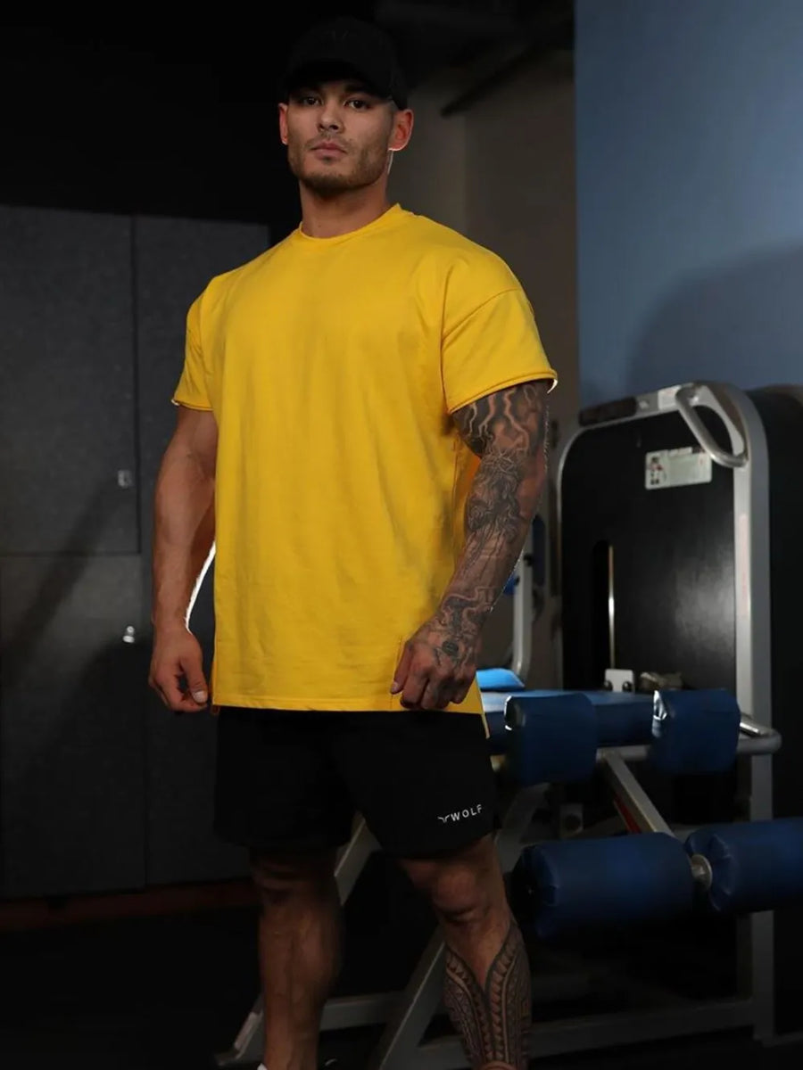 Oversized gold crew neck tee with textured fabric and short sleeves.