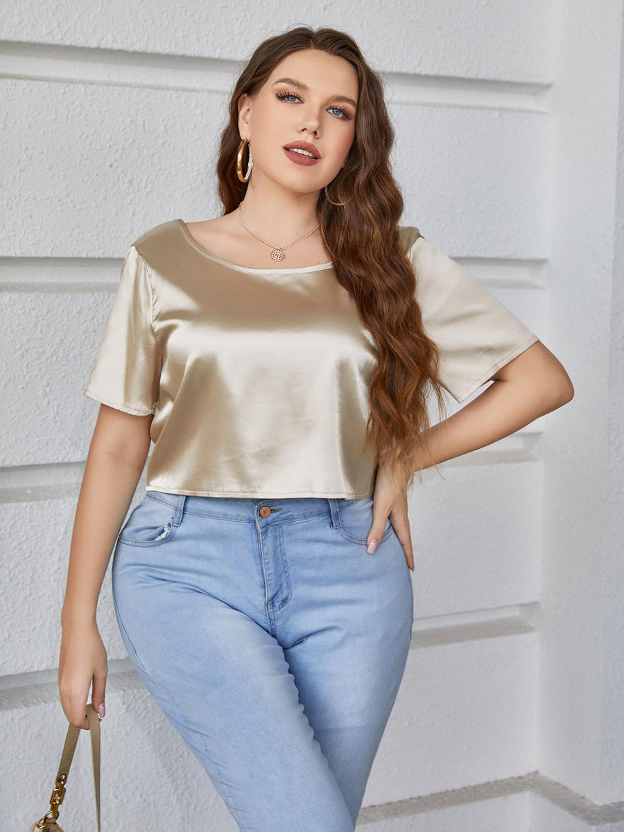 Gold satin blouse with short sleeves and a scoop neck.