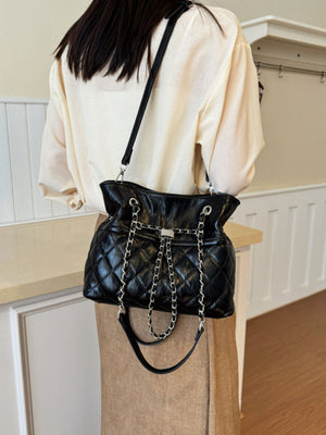 Black handbag featuring quilted and quilted