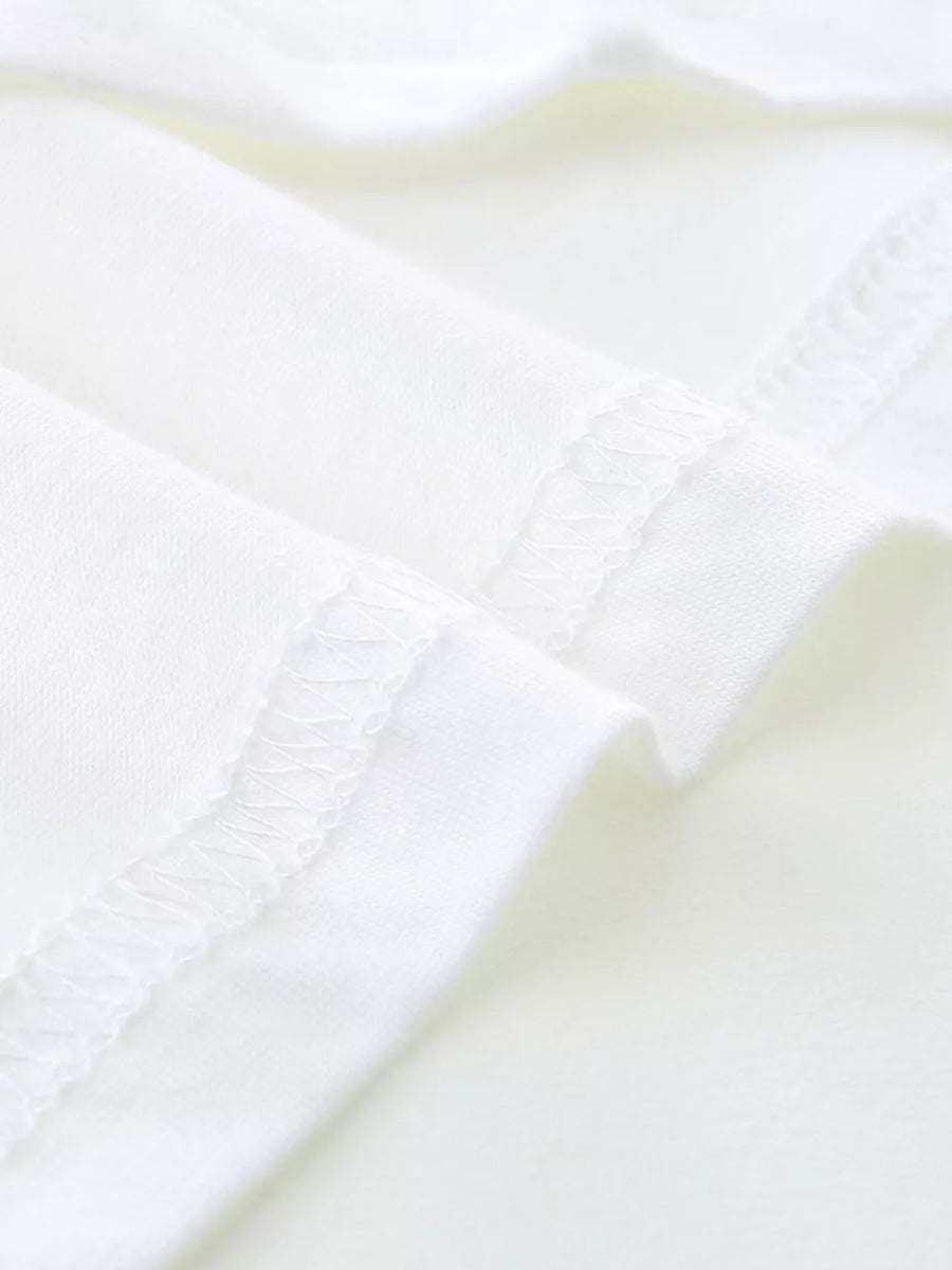 White cotton toddler t-shirt detail showing stitched seams