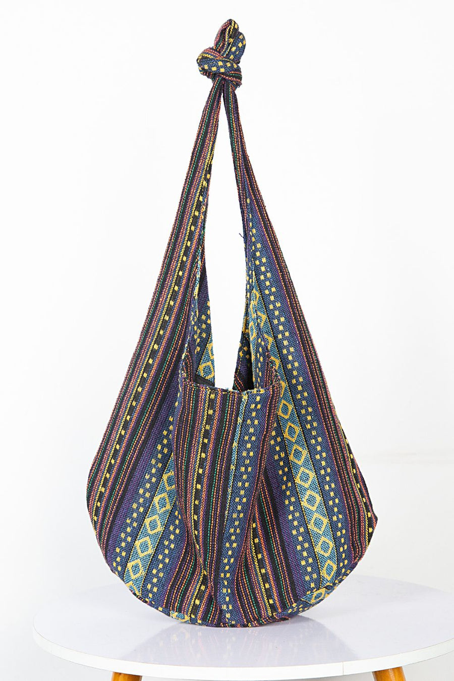 Tribal weave shoulder bag with geometric patterns in blue, purple, and yellow.