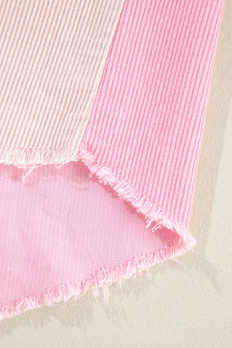 Colorblock corduroy shacket in blush pink with raw edges and vertical stripes.