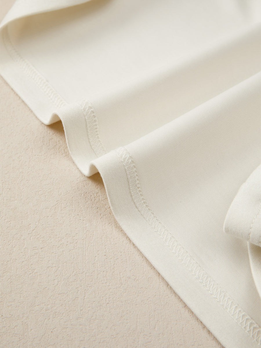Beige buttoned blouse with visible stitching detail
