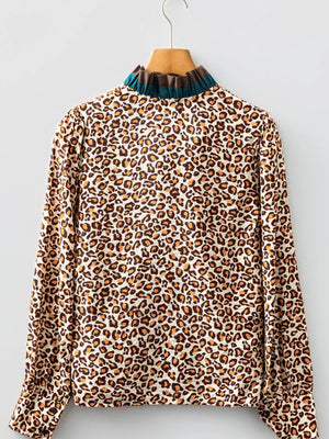 Leopard print button-down shirt with a frilled mock neck and long sleeves.