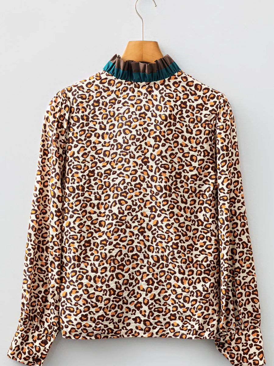 Leopard print button-down shirt with a frilled mock neck and long sleeves.