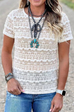 White sheer lace t-shirt with short sleeves and intricate pattern.