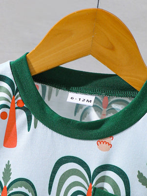 Baby tee and shorts set with tropical palm print, green trim, and cotton fabric.