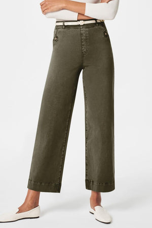 Wide-leg utility denim trousers in olive brown with button details and a white belt.