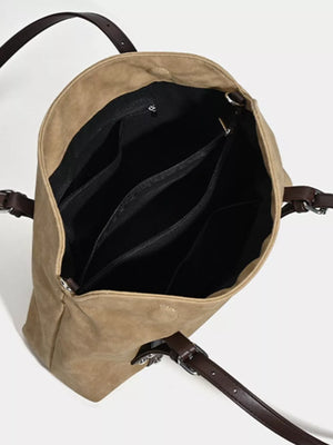 Brown suede medium shoulder bag with adjustable straps and interior pockets.