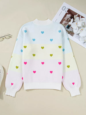 Women's crew neck knit sweater with colorful heart pattern and pastel stripes.