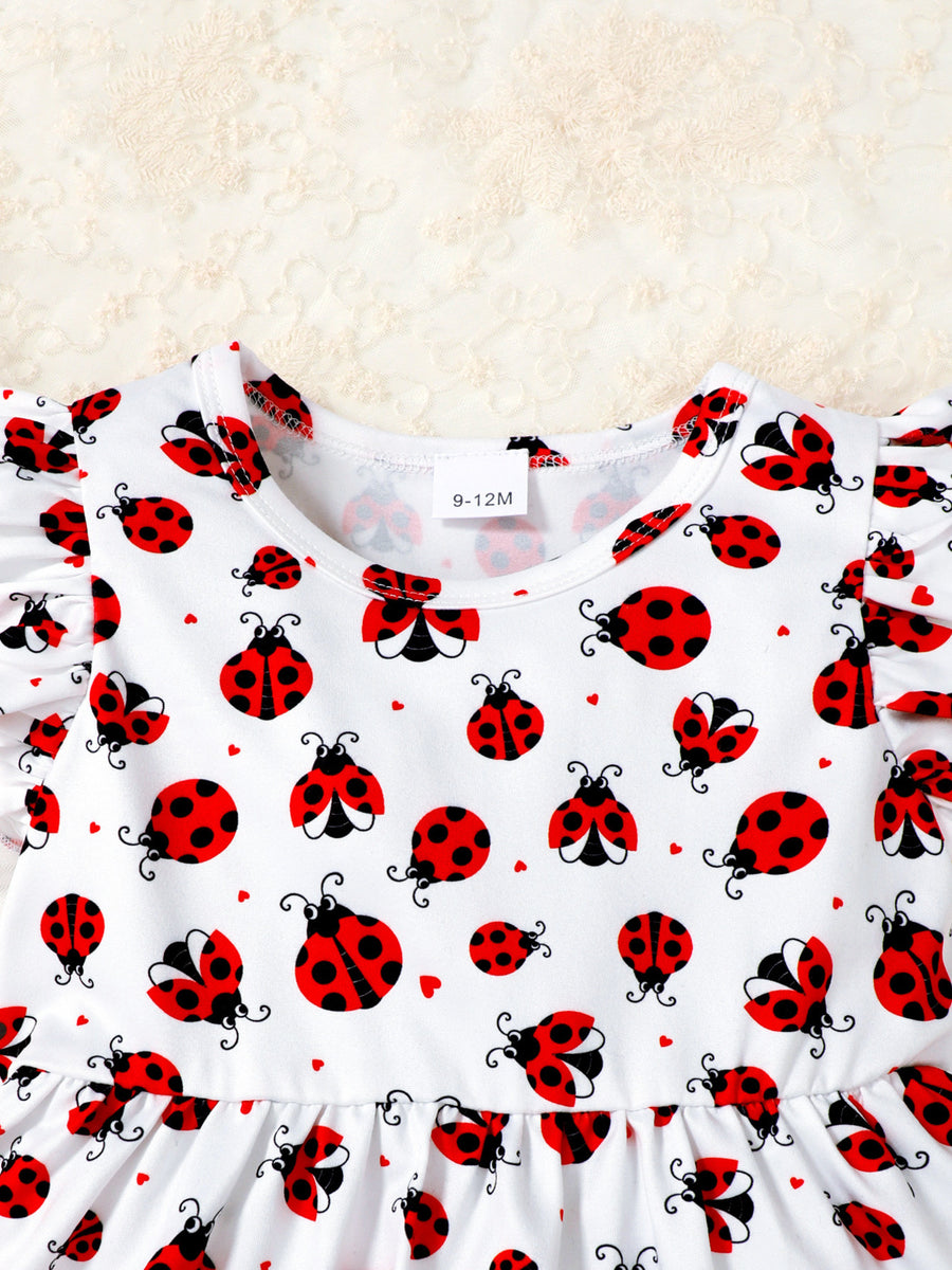 Baby set with white fabric, red ladybug print, and ruffle trim sleeves.