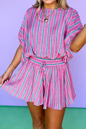 Vibrant stripe two-piece set with drawstring shorts and dolman sleeve top in fuchsia and teal.