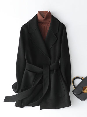 wool coat in black featuring pocketed and regular fit