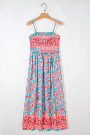 Bohemian floral maxi dress with smocked pink bodice and blue floral print skirt.