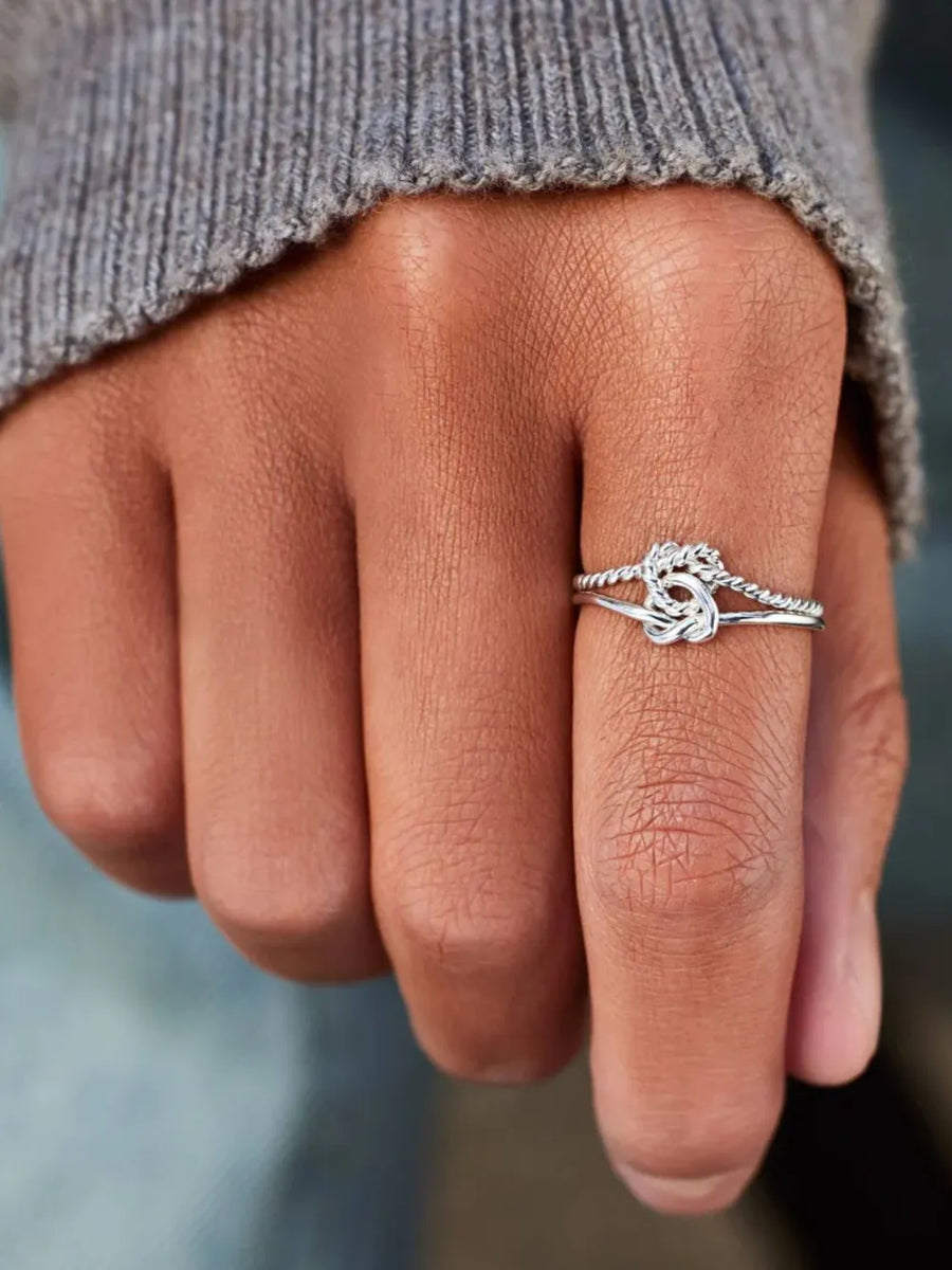 Silver rope knot ring in 925 sterling silver with twisted band detail.