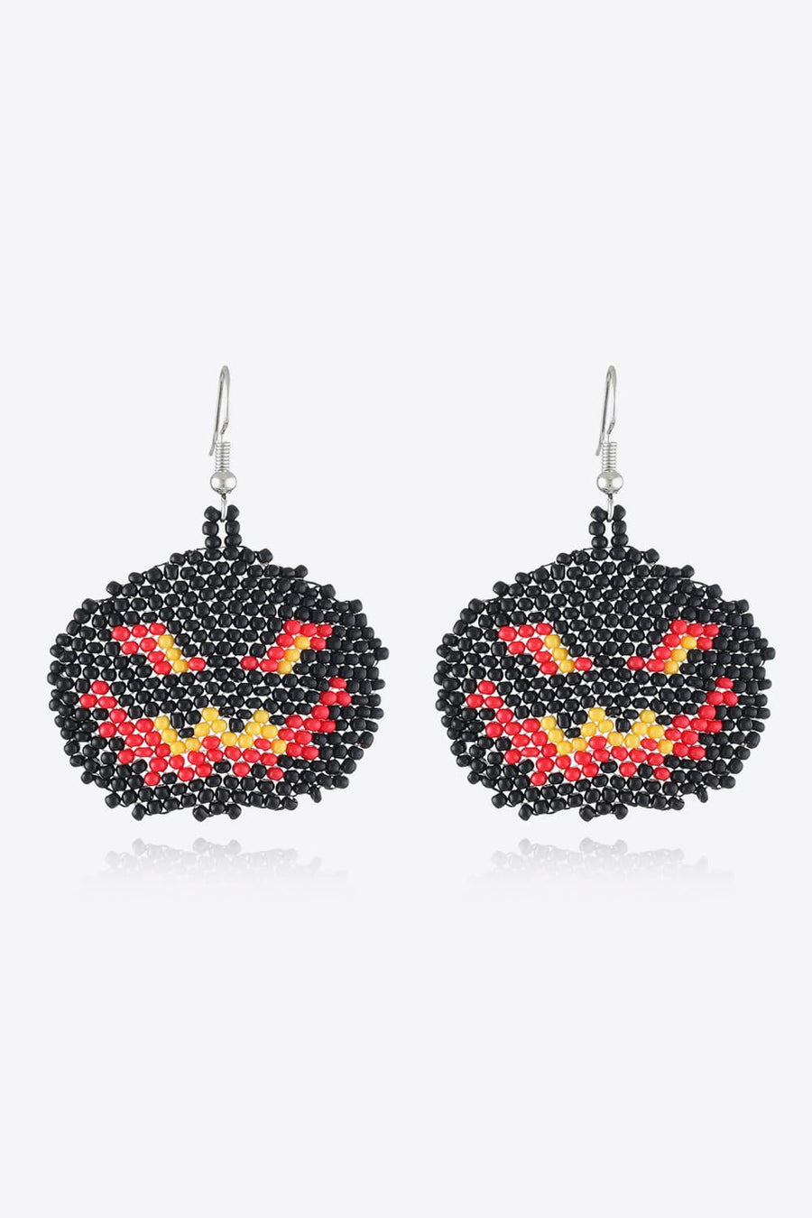 Beaded pumpkin earrings in black with red and yellow jack-o-lantern faces.