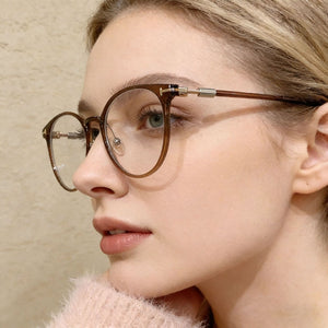 Translucent round frame eyeglasses in caramel with gold accents.