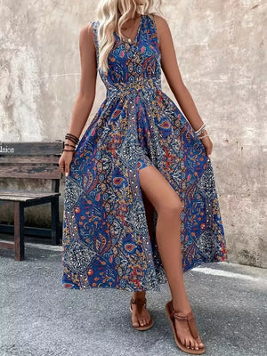 Maternity swim dress in Peacock Blue with vibrant paisley print, V-neck, cinched waist, and dramatic slit.