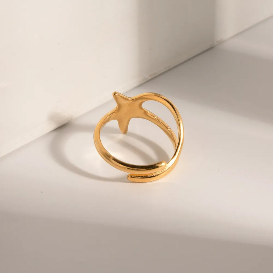 Gold adjustable ring with a starfish silhouette design.